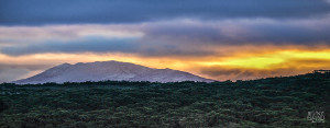 Snowcapped mountain sunset photo taken from South Bruny towards Hartz Mountains National Park